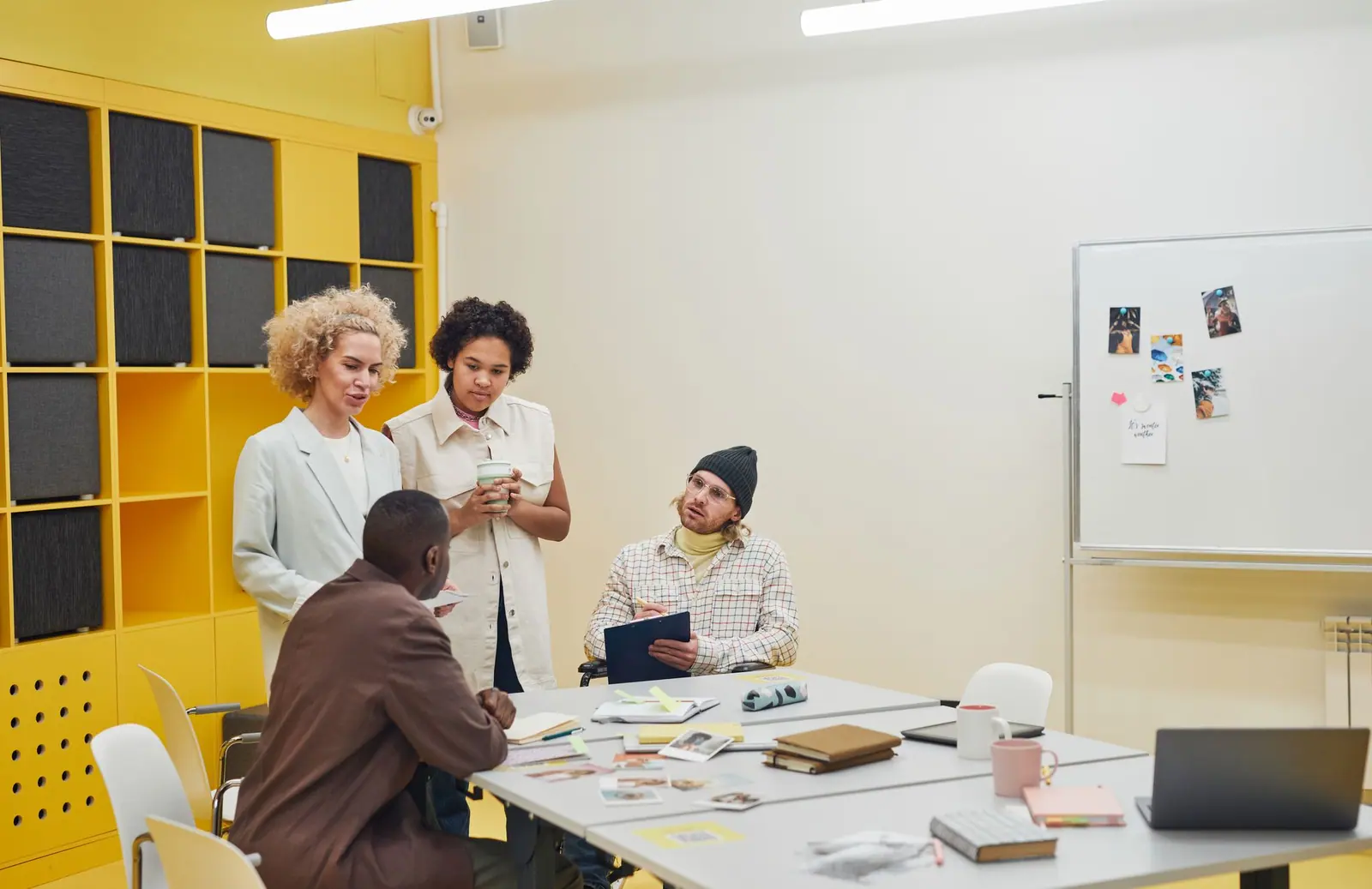 A small team talking together around a table in an office
